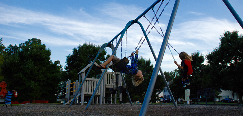 kids swinging on large swings